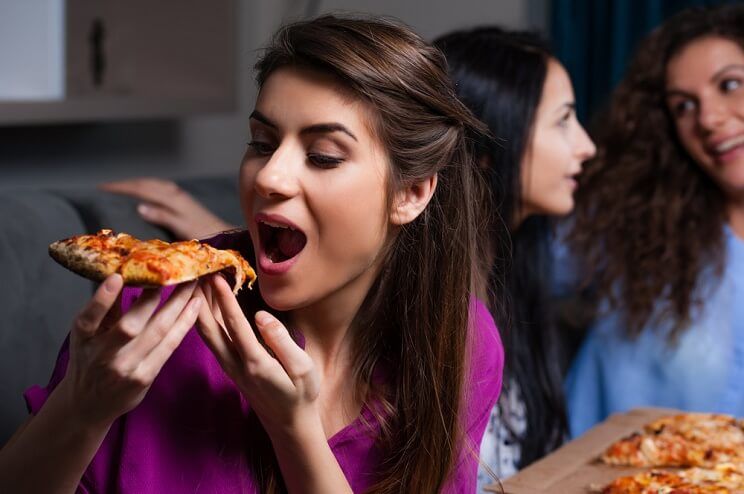 woman eating pizza