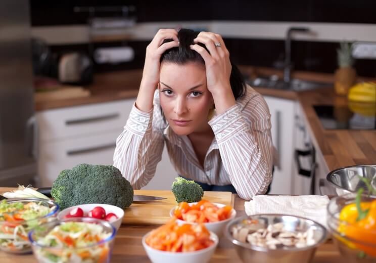 frustrated woman surrounded by healthy food