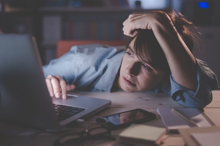 tired woman in front of a computer