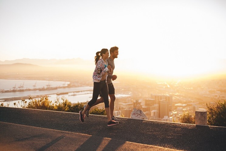 young couple jogging at sunset