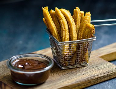 Bite into these crispy sweet potato churros dunked in a rich, dark chocolate sauce. These crunchy sweet potato churros are great for parties.