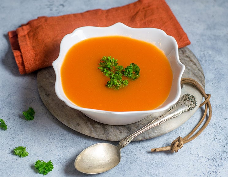 Veggies get roasted until caramelized, then blended with warm spices and savory broth for a creamy carrot and ginger soup bursting with flavor.